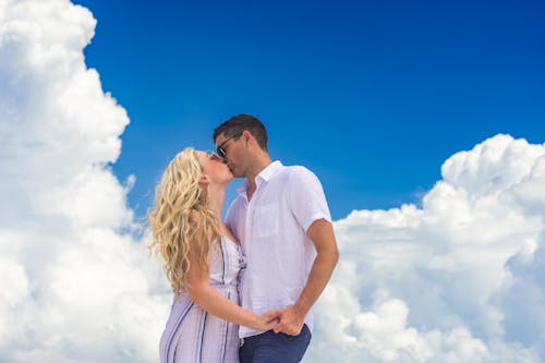 Man and woman kissing and holding hands