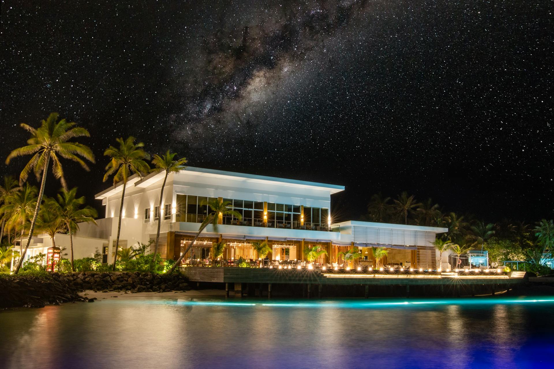 Beautiful seafront resort illuminated under a star-studded sky, perfect for exotic vacations and serene retreats.