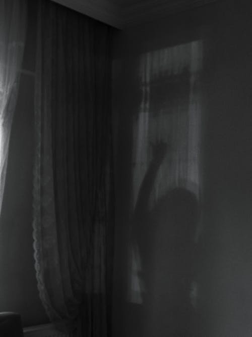 Woman Shadow behind Curtains