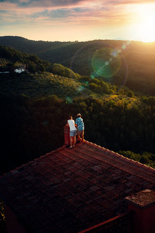 Men Standing on Roof