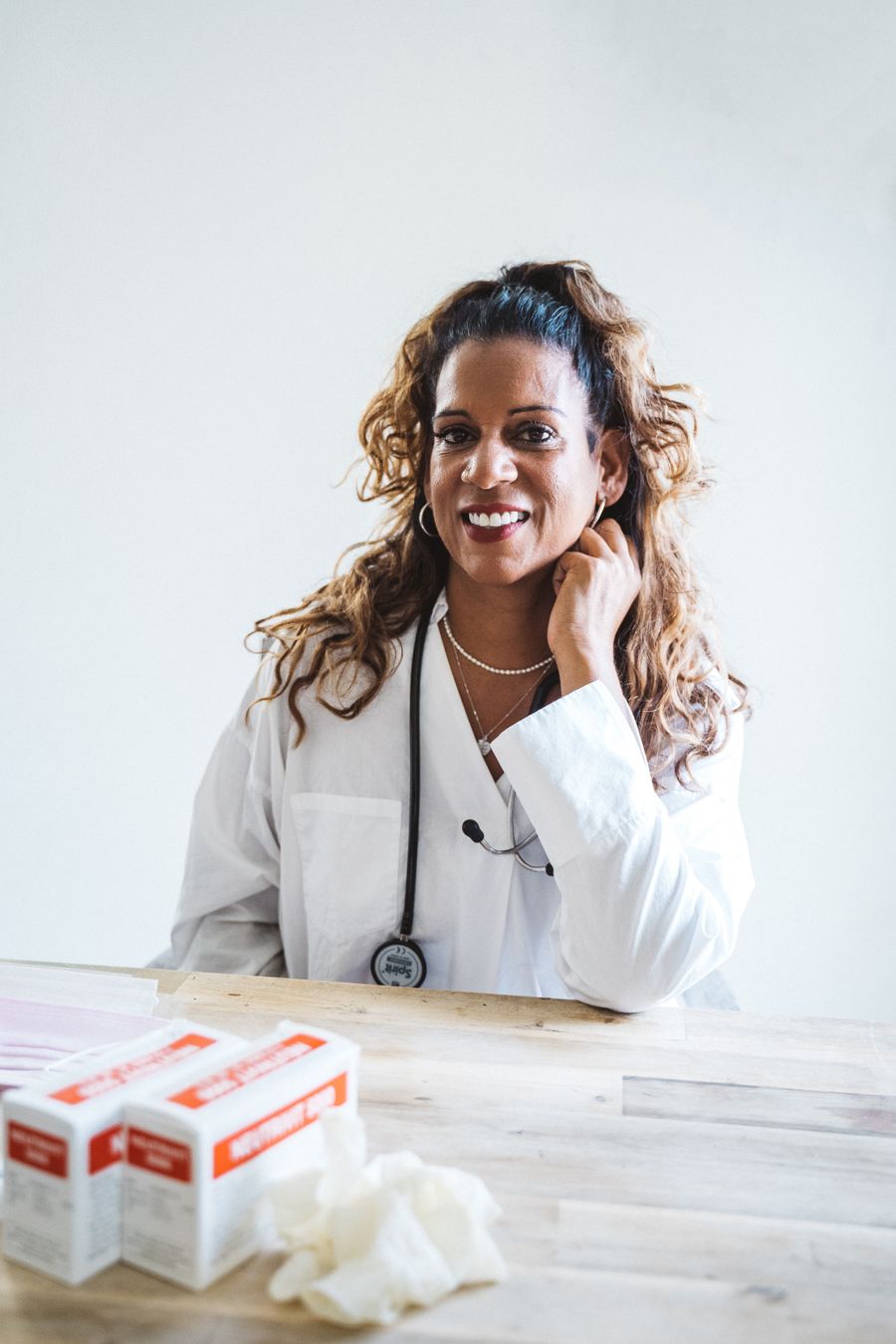 Dr. Sophia Reynolds, female doctor with curly hair in a lab coat