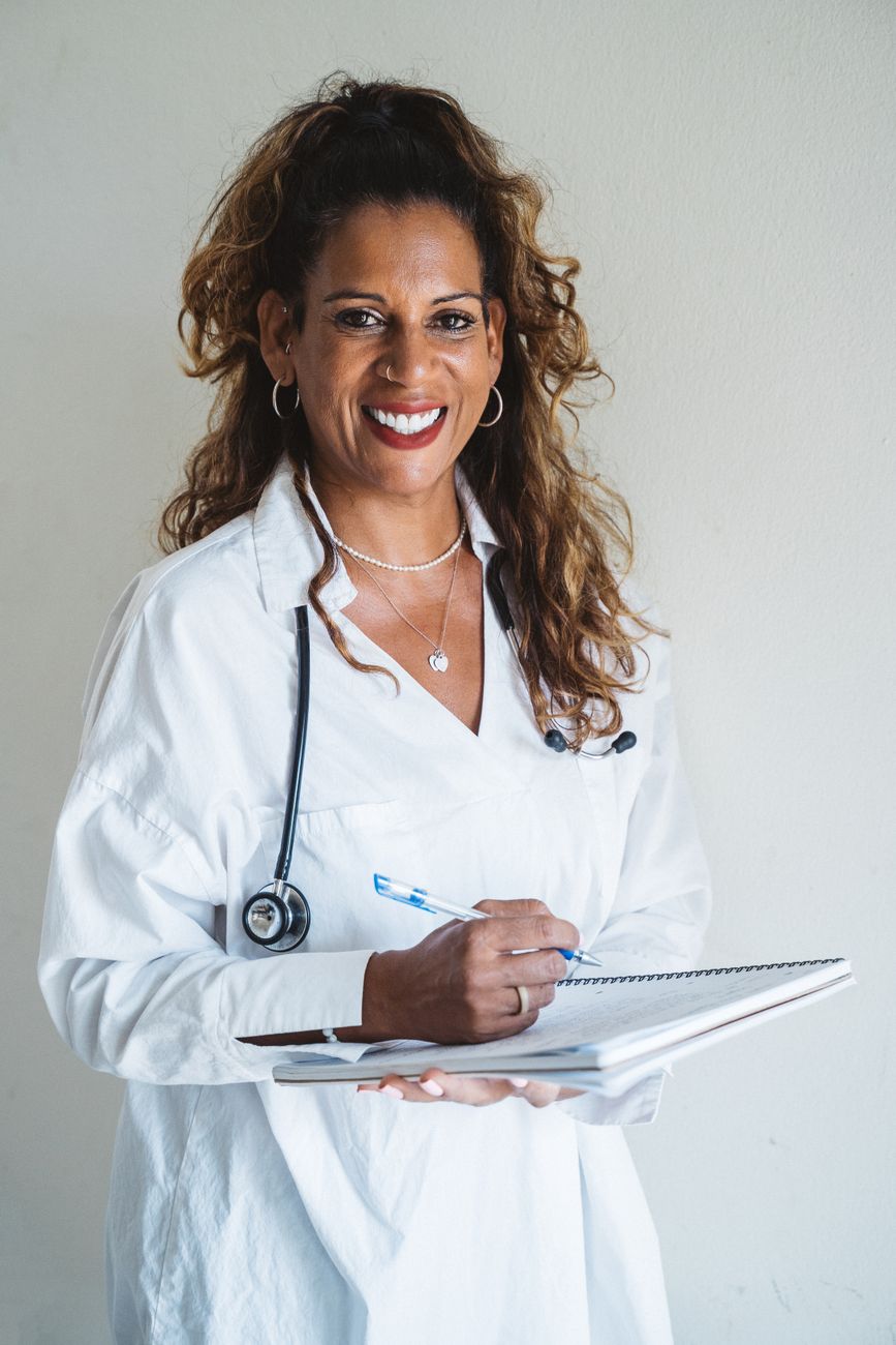 Dr. Elena Marsh, chief aesthetic surgeon, smiling in a white coat