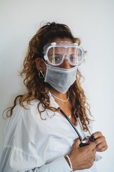 Portrait of a healthcare worker wearing protective gear, including goggles and a face mask.
