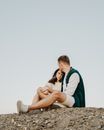Loving couple sitting on ground