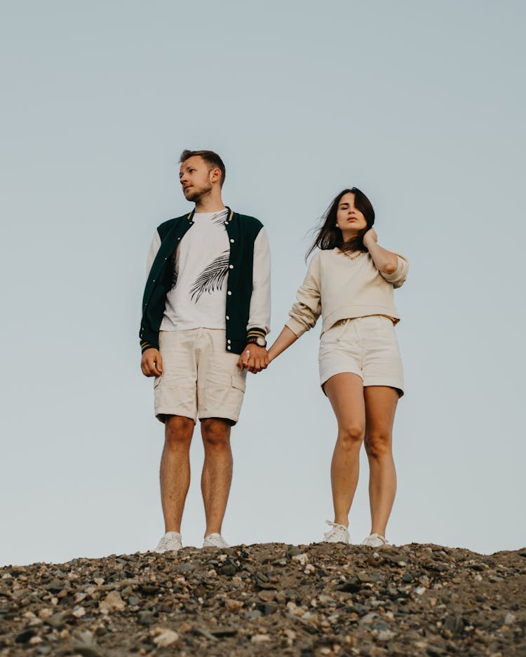 Stylish Couple Standing On Rocky Ground