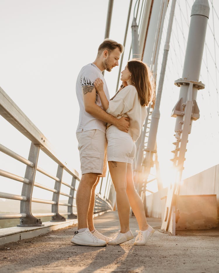 Cute Couple Hugging On Bridge