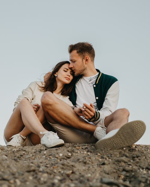 Free Happy couple embracing on rocky terrain Stock Photo