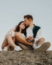 Happy couple embracing on rocky terrain