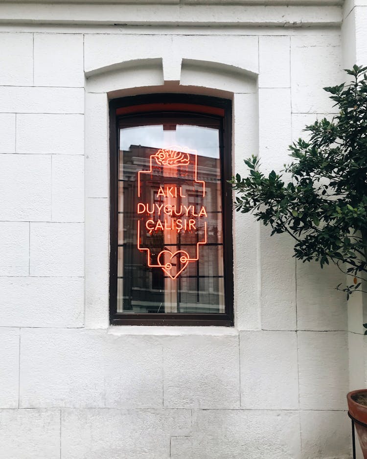 A Neon Sign In A Window