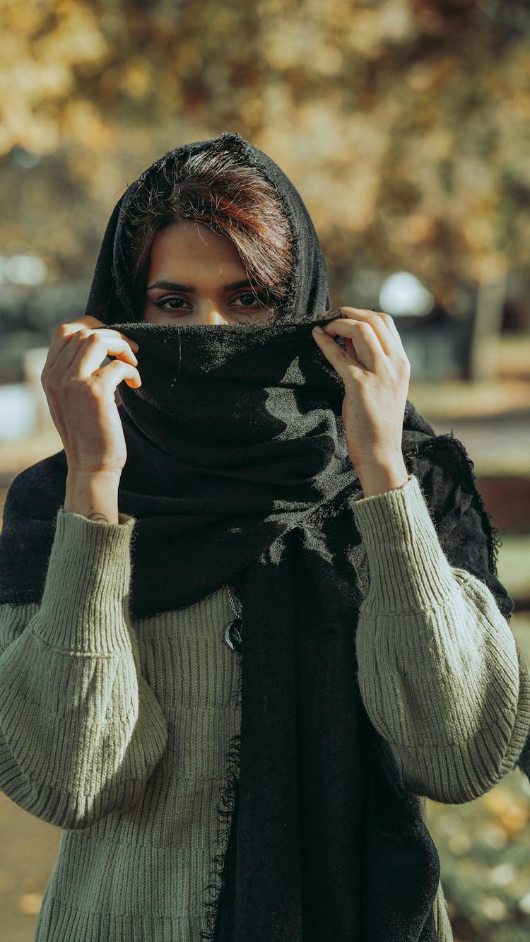 Woman Covering Face With Scarf