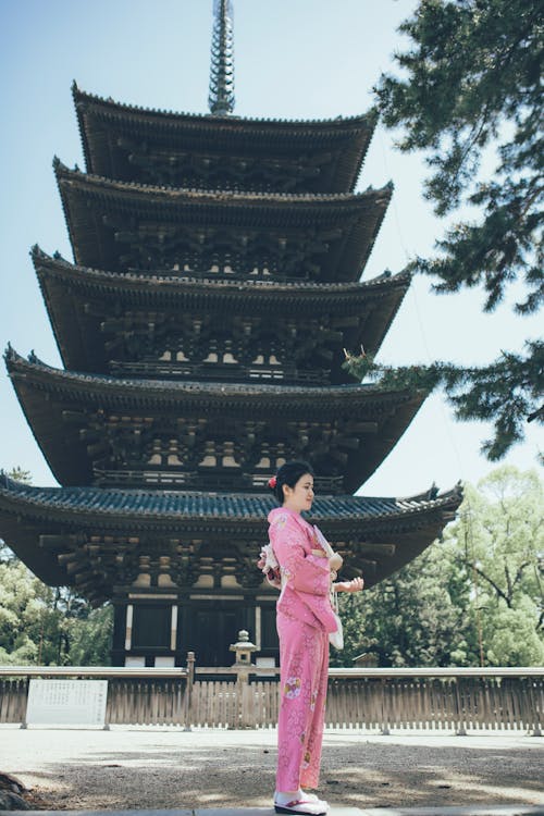 Woman Standing by a Japanese Shrine