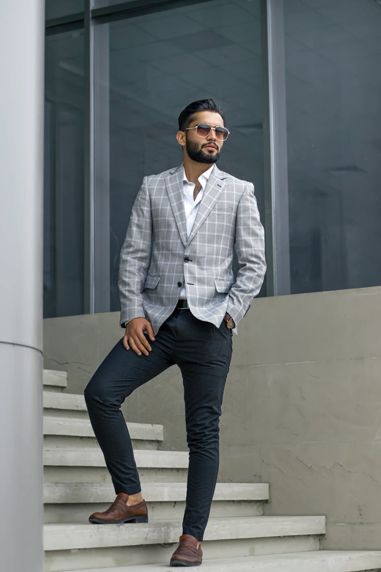 Man In Plaid Suit Jacket Standing On Concrete Stairs