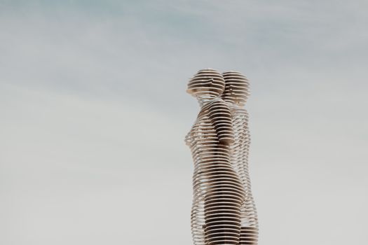 Gray Concrete Statue Under White Clouds