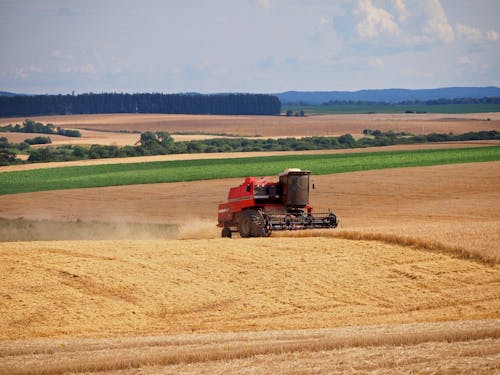 Free Red Tractor on Brown Field Stock Photo