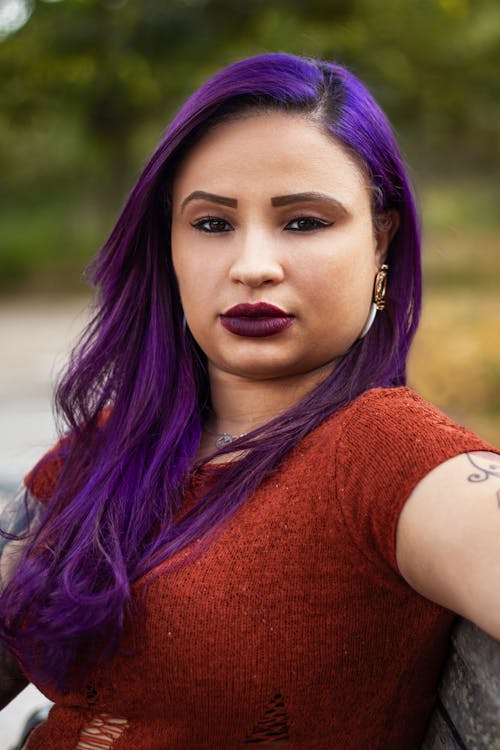 Portrait of a Beautiful Woman with Purple Hair Looking at the Camera