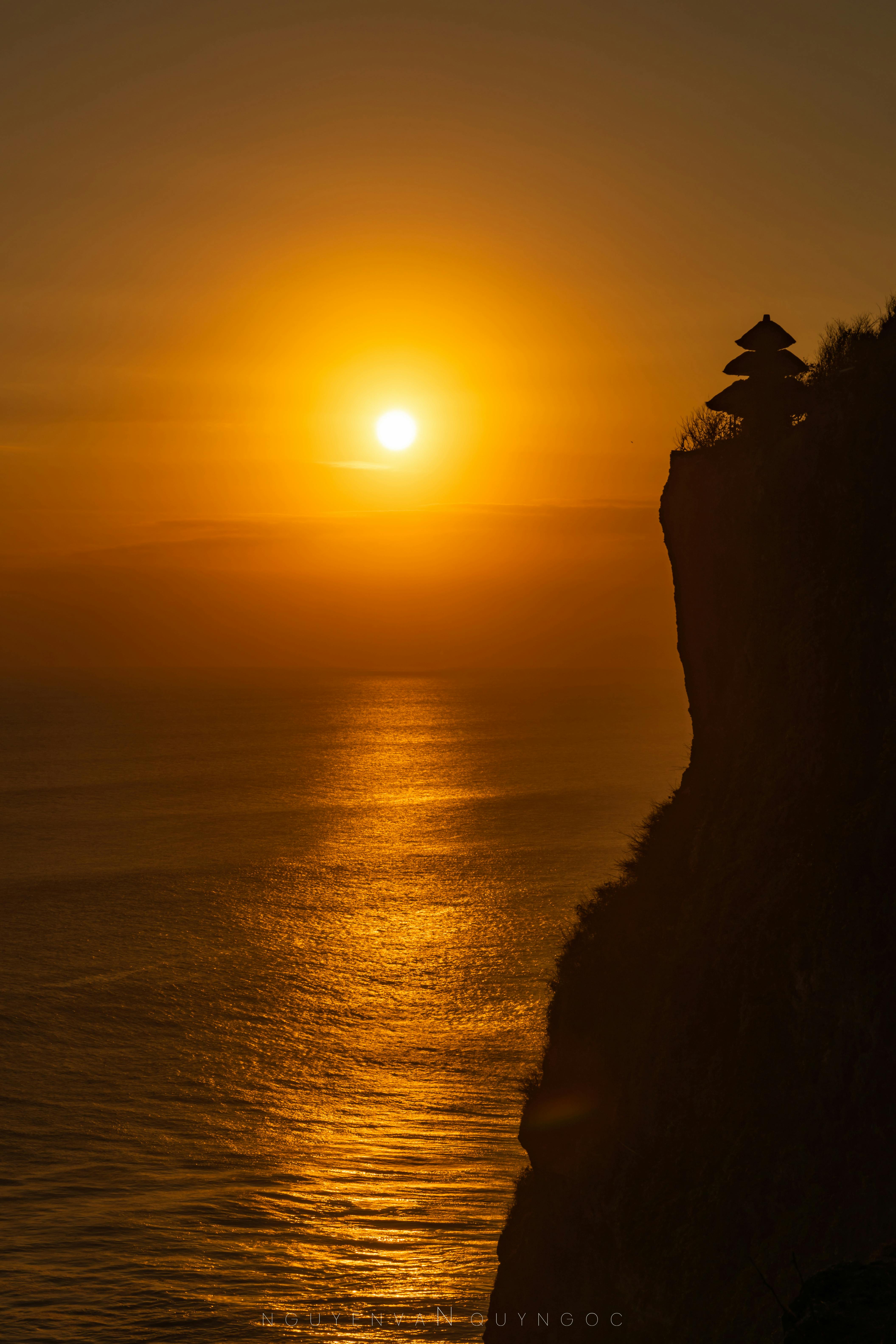 Uluwatu Temple perched on cliff above the Indian Ocean during golden hour before the Kecak Fire Dance Bali sunset performance