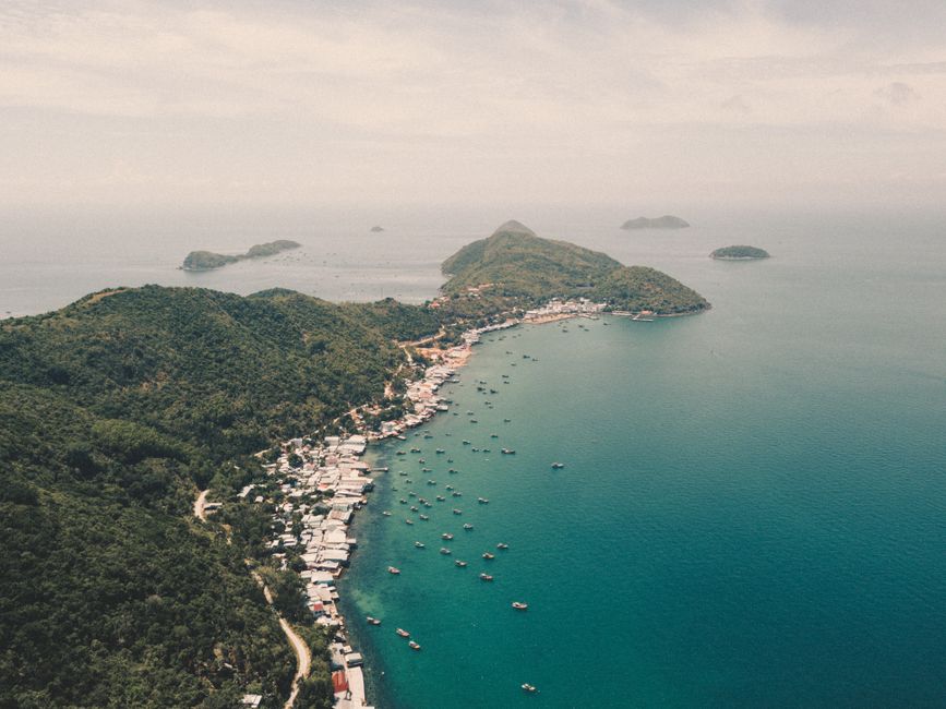 Stunning aerial view of Kien Giang coast with lush green mountains and clear blue sea in Vietnam.