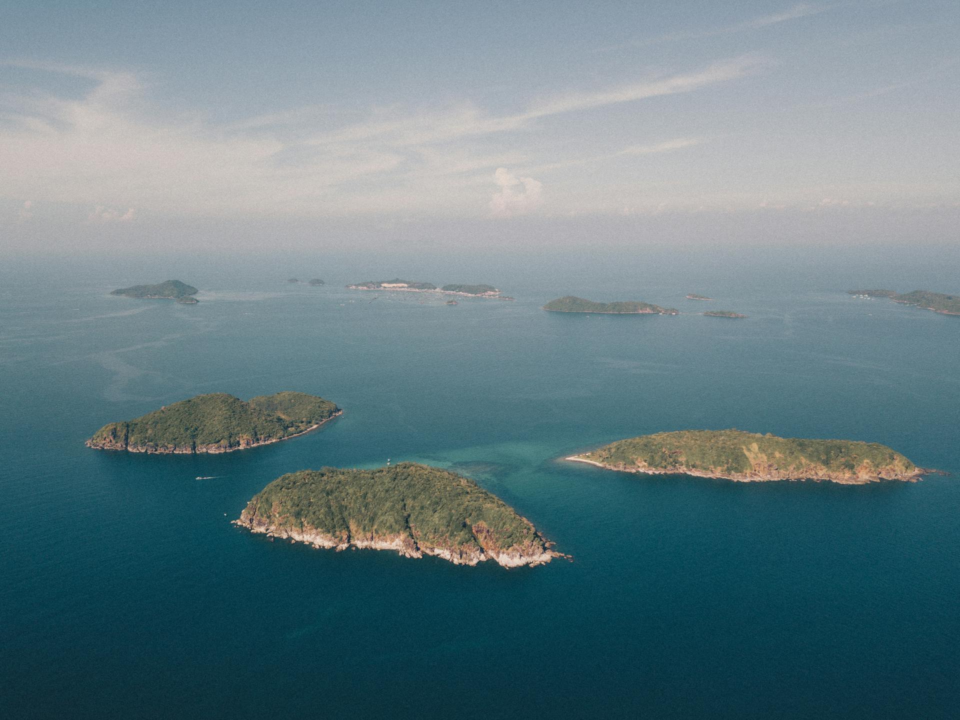 Scenic aerial view of islands in Kien Giang, Vietnam with vibrant blue ocean waters.