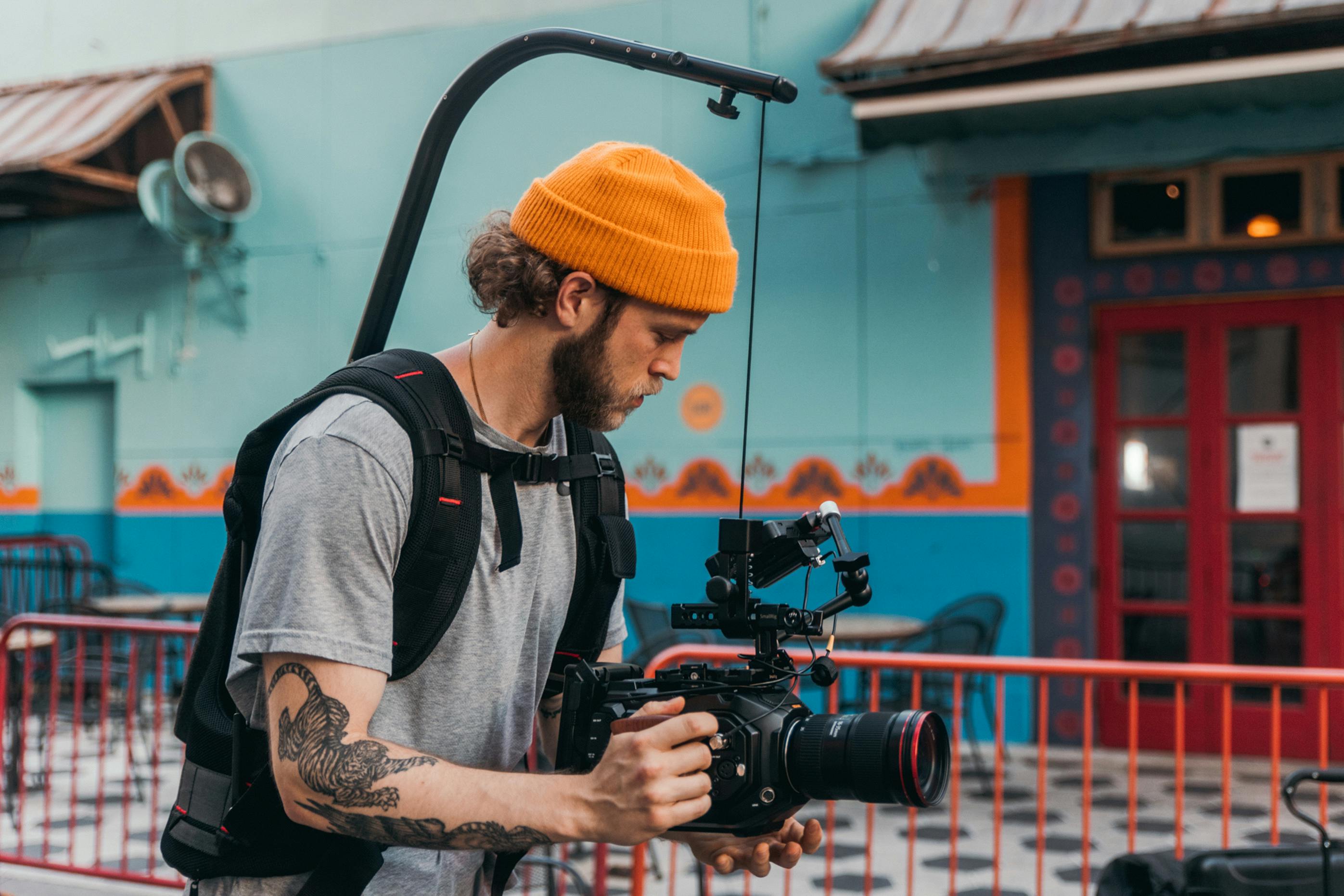 man in gray crew neck t shirt holding black camera