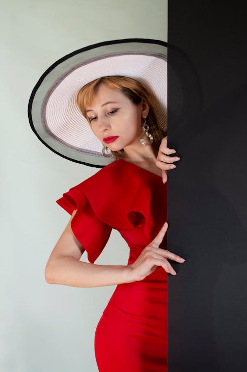 Beautiful Woman in a Red Dress Wearing a Hat