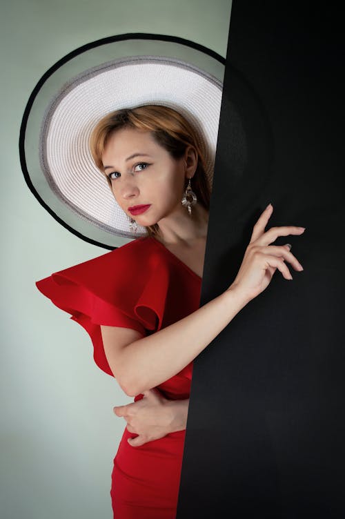 A Woman in a Red Dress and a Big Hat