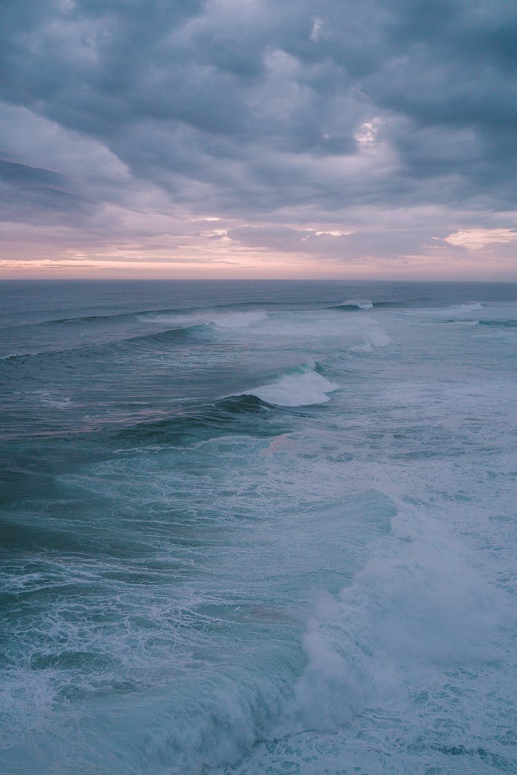 Ocean Waves Under A Cloudy Sky