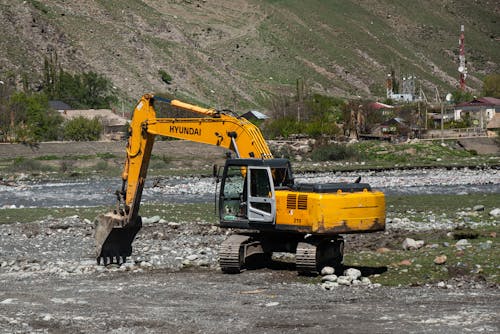 A Power Shovel on a Rocky Ground with Near a Mountain