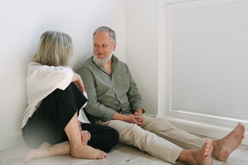 Man and Woman Sitting on the Floor
