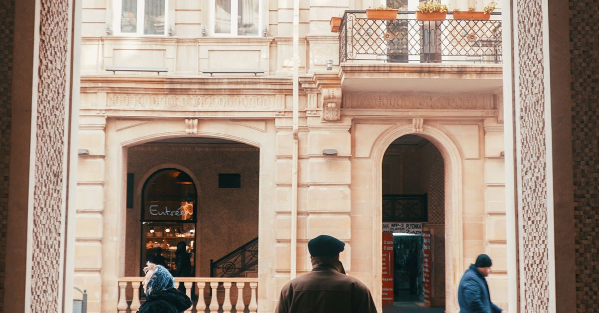 People Standing Behind Railing A Man Standing and Waiting Behind a Railing · Free Stock Photo