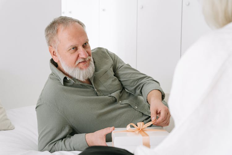 A Man Holding A Gift