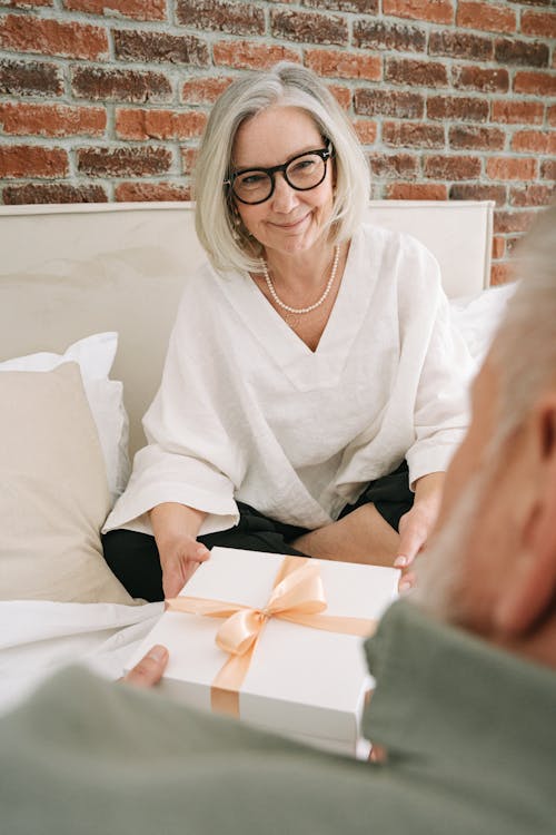 Free Person Giving Gift to an Elderly Woman Stock Photo