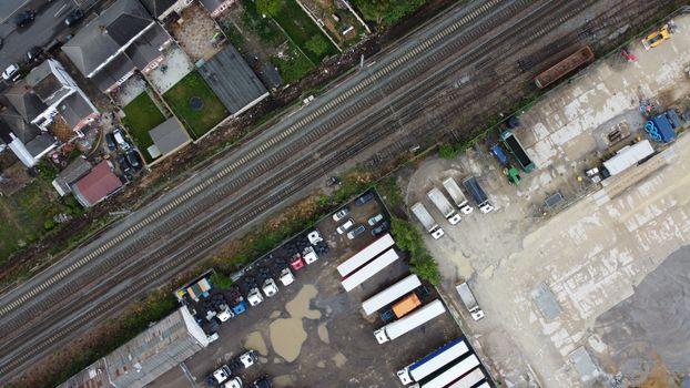 Aerial photo displaying a railway next to an industrial area and residential neighborhood in Maidenhall, England.