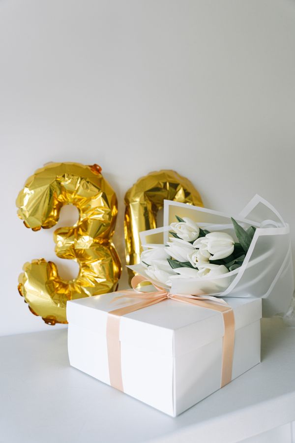 Colorful birthday flower bouquet with balloons and a greeting card