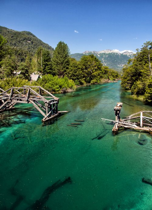 Free A picturesque broken bridge over a turquoise river in San Martín de los Andes, Argentina. Stock Photo