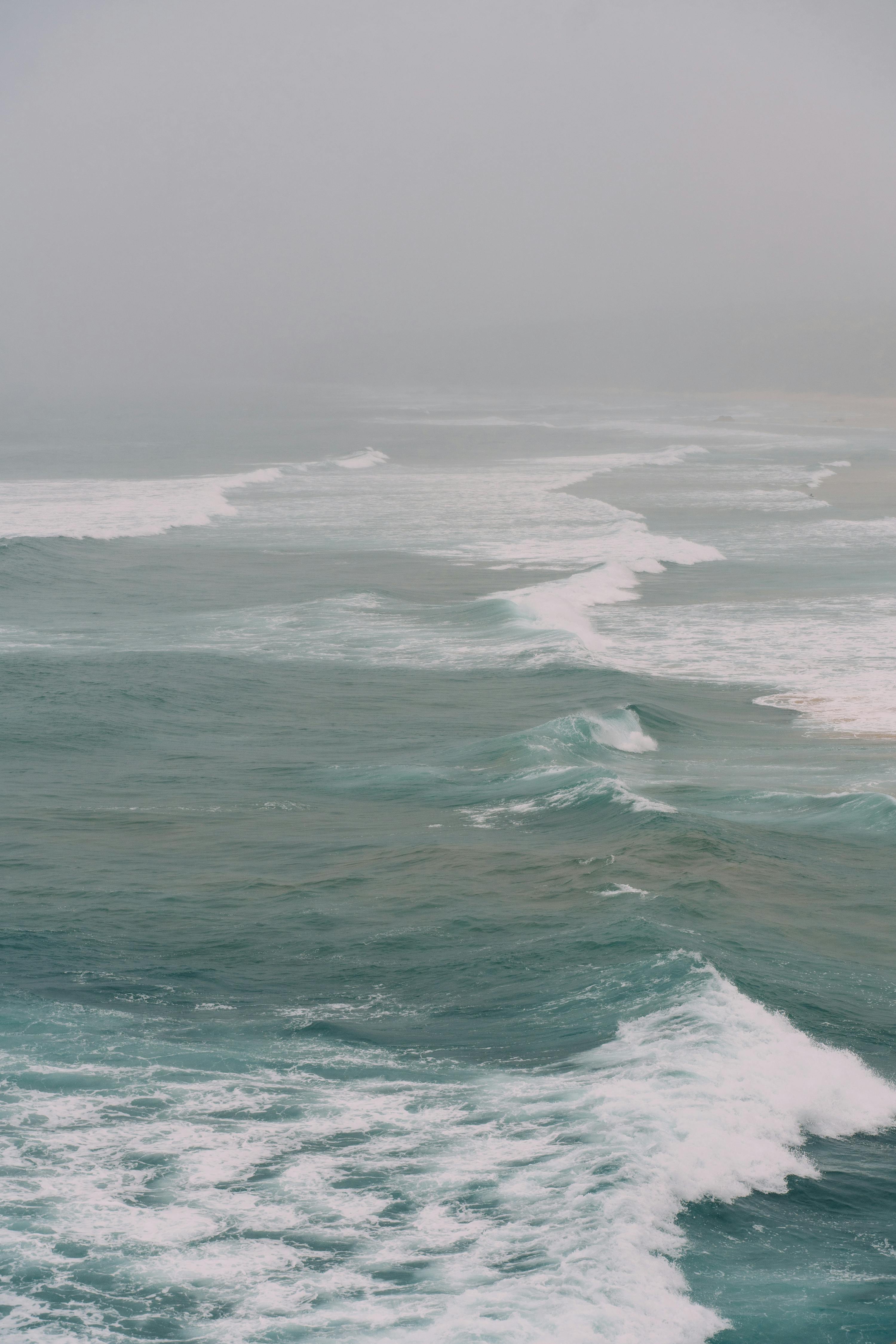 A dramatic aerial shot of ocean waves crashing along the Portuguese coast, showcasing nature's power.