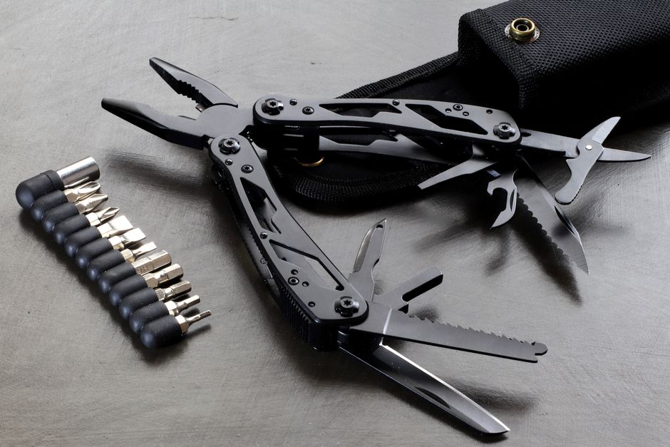 A compact multi-tool with attachments displayed on a table