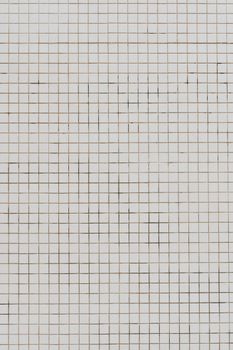 A high-resolution image of a symmetrical tiled wall with a neutral color palette.