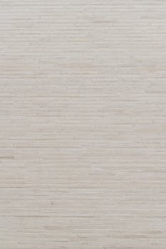A minimalist beige wall with subtle linear patterns, perfect for design and backgrounds.