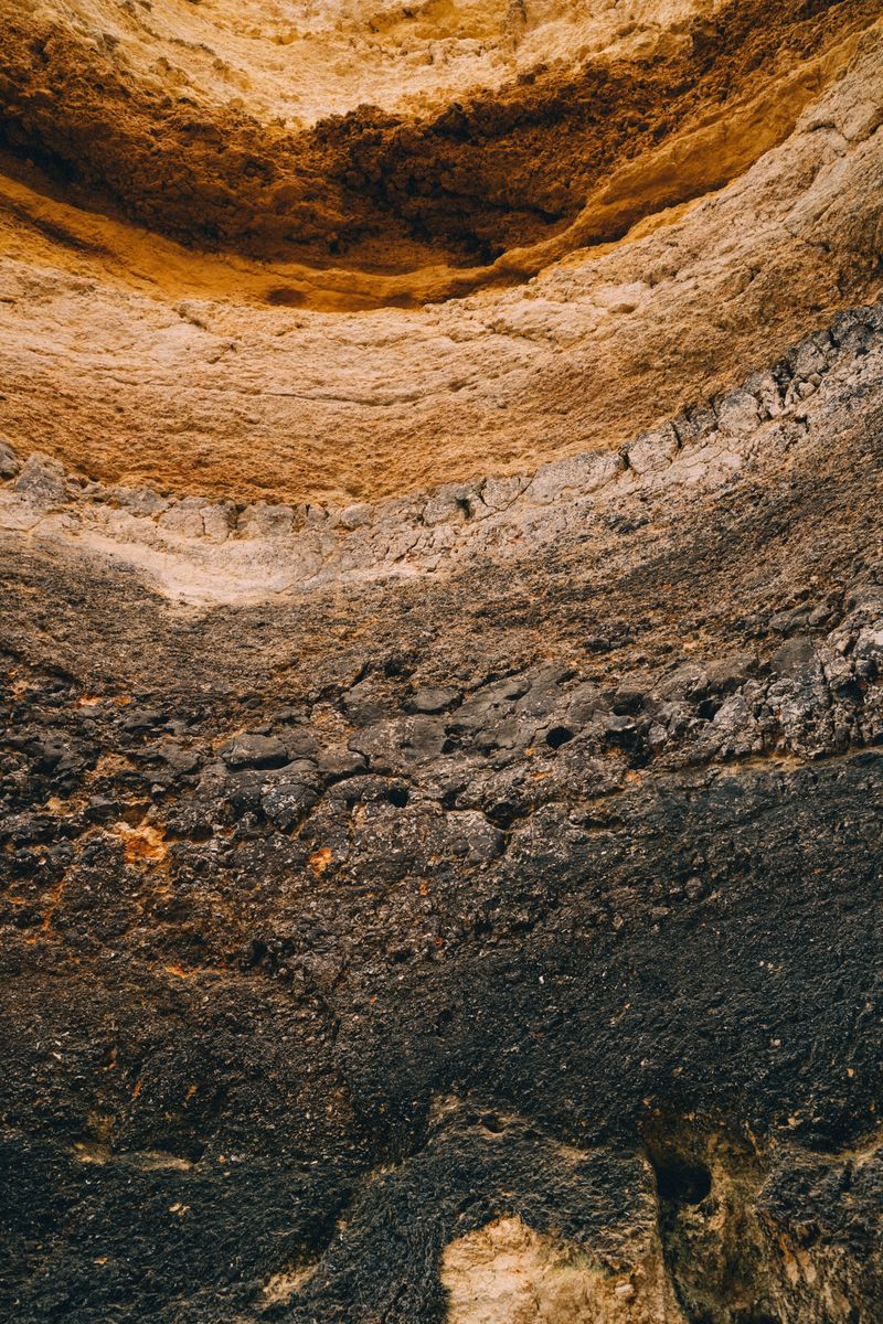 Detailed view of a layered rock formation showcasing diverse geological textures and colors