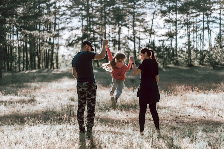 Happy Family Walking In Forest