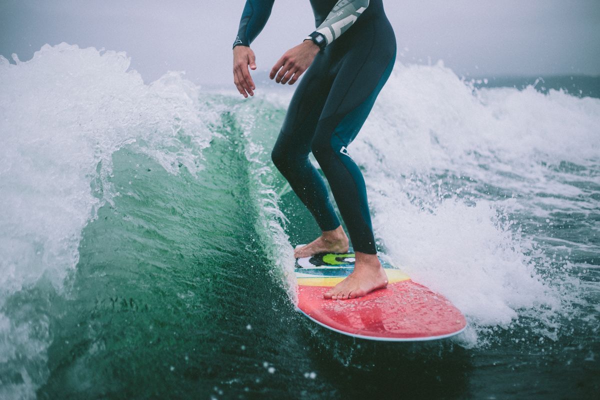 Rider surfing the wake behind a boat on a lake