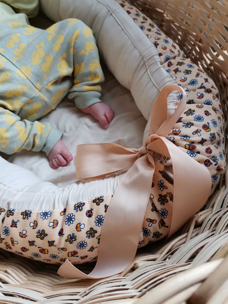 A Baby Lying On The Basket