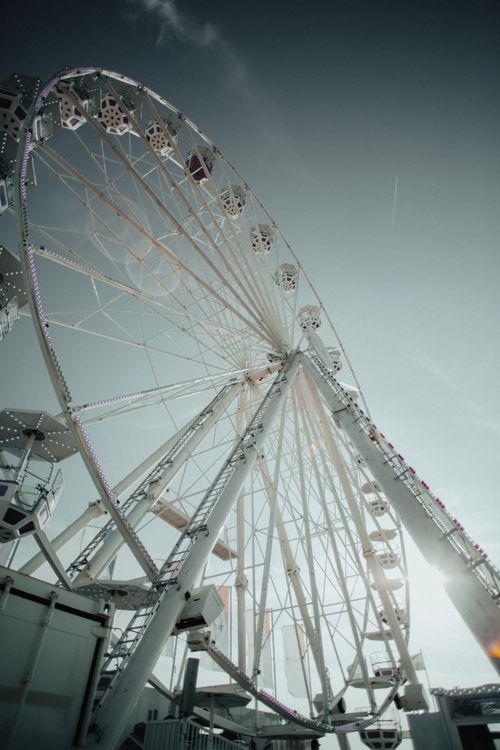 Free A majestic Ferris wheel shot from below against a clear sky, creating a sense of wonder. Stock Photo