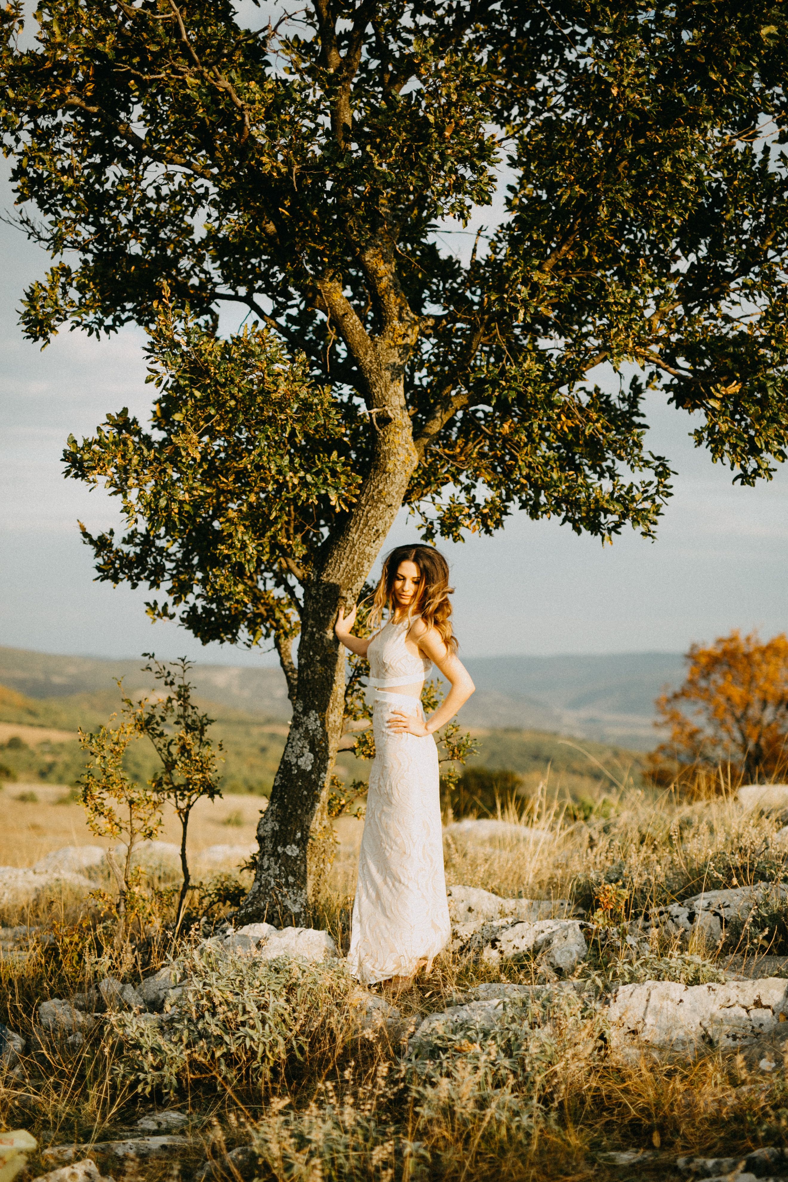 Woman in White Dress Standing Beside a Tree · Free Stock Photo