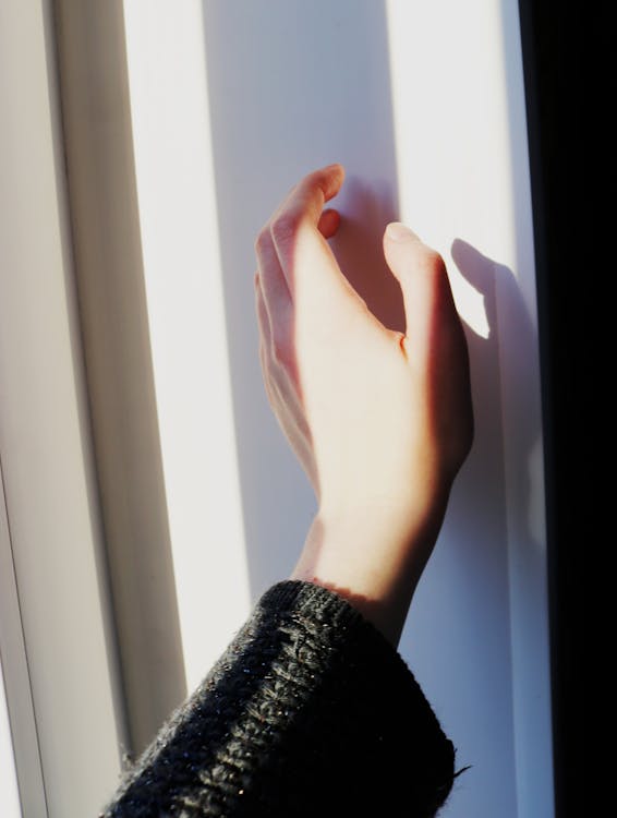 Hand Beside a White Wall