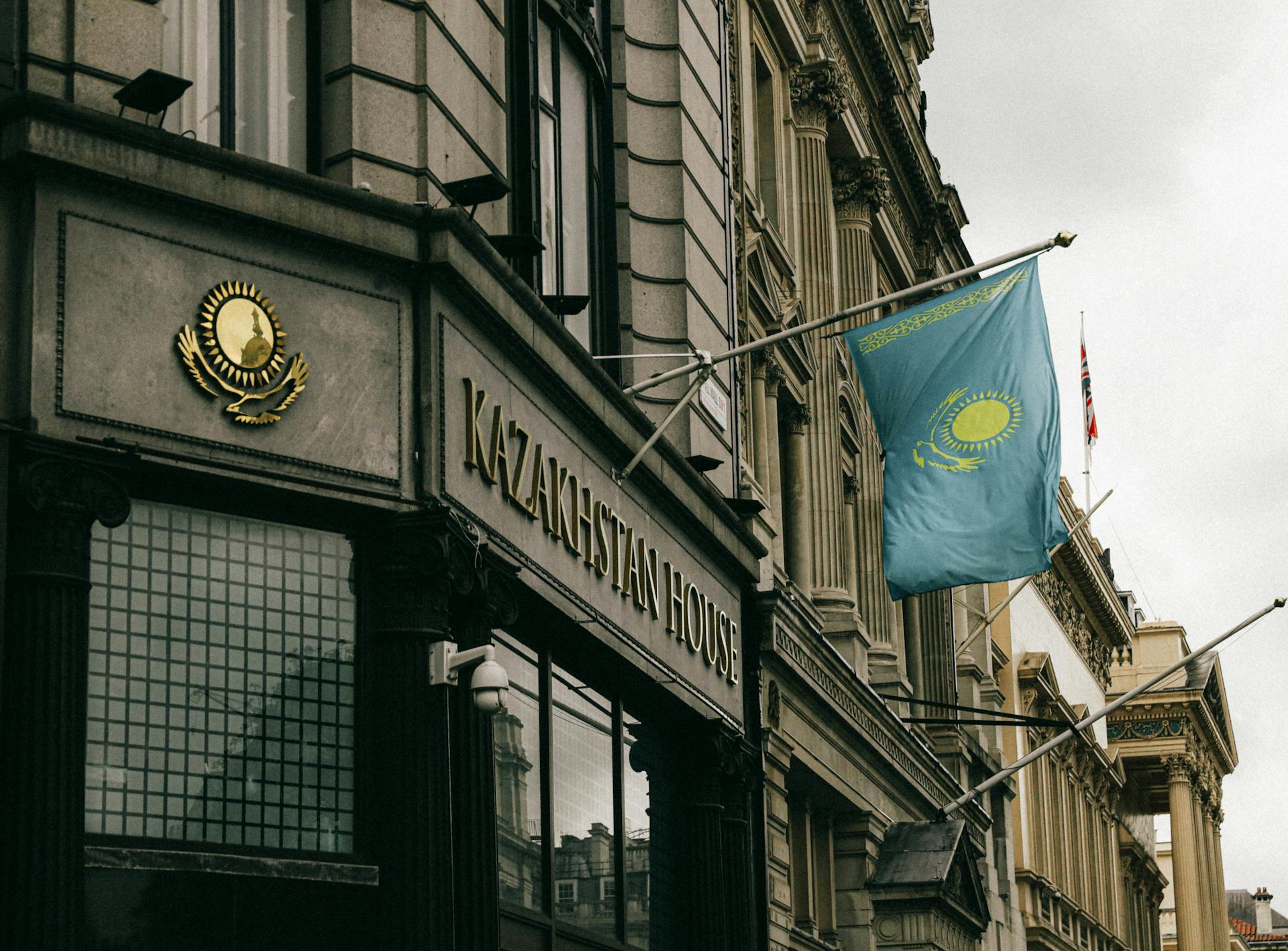 Kazakhstan House facade with flag and emblem in London, showcasing diplomacy and architecture.