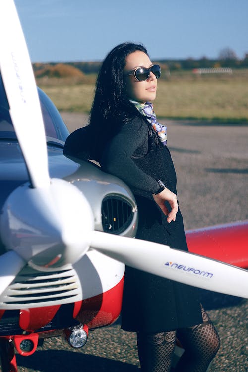 Woman Leaning on an Airplane