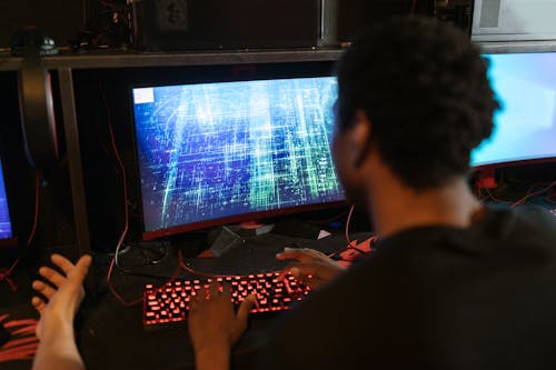 Free Man Using a Gaming Computer Stock Photo