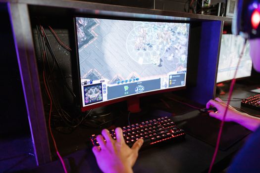 Engaging in an online gaming session with a modern setup, highlighting technology and recreation.