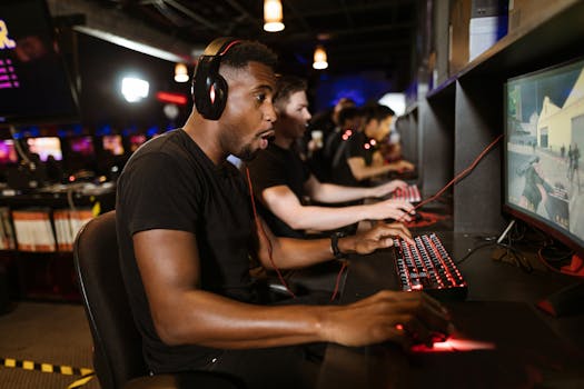 Group of gamers engaging in eSports on gaming computers in an arcade.